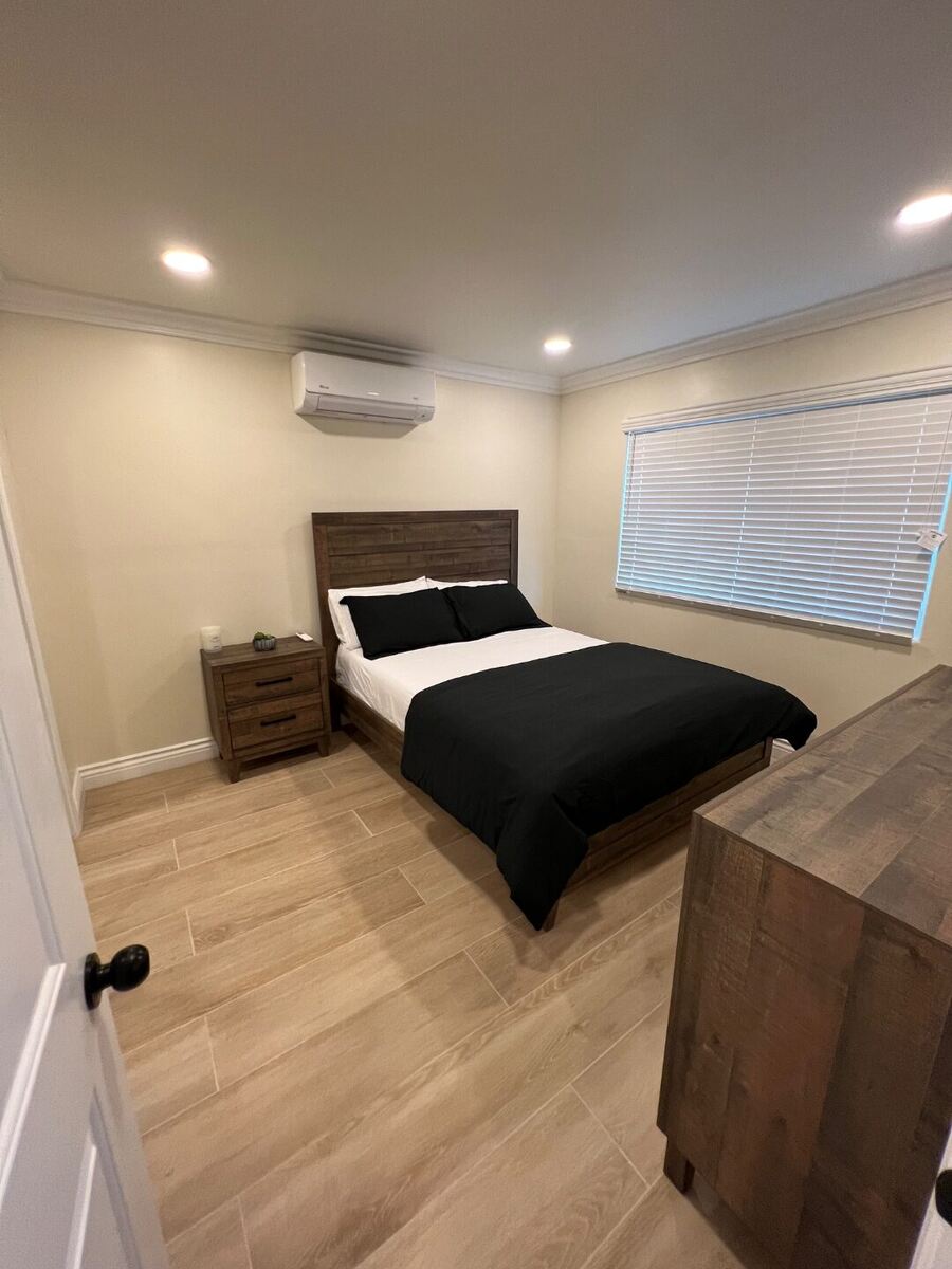 Bedroom at Her Aria with mini-split climate control and mirrored closet